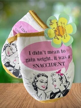 Funny set of oven mitts. enforced grip padding. “Oops. I had a snaccident.”